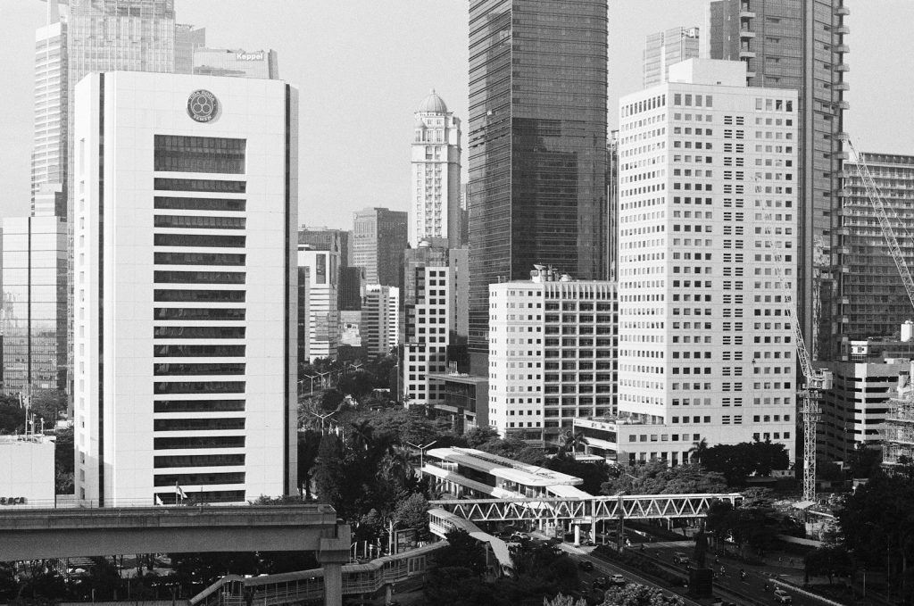 Modern skyscrapers and urban infrastructure in black and white.