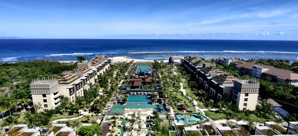an aerial view of a resort by the ocean