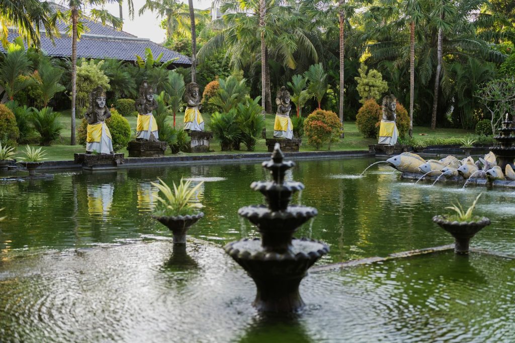 A tranquil garden with a fountain and statues.